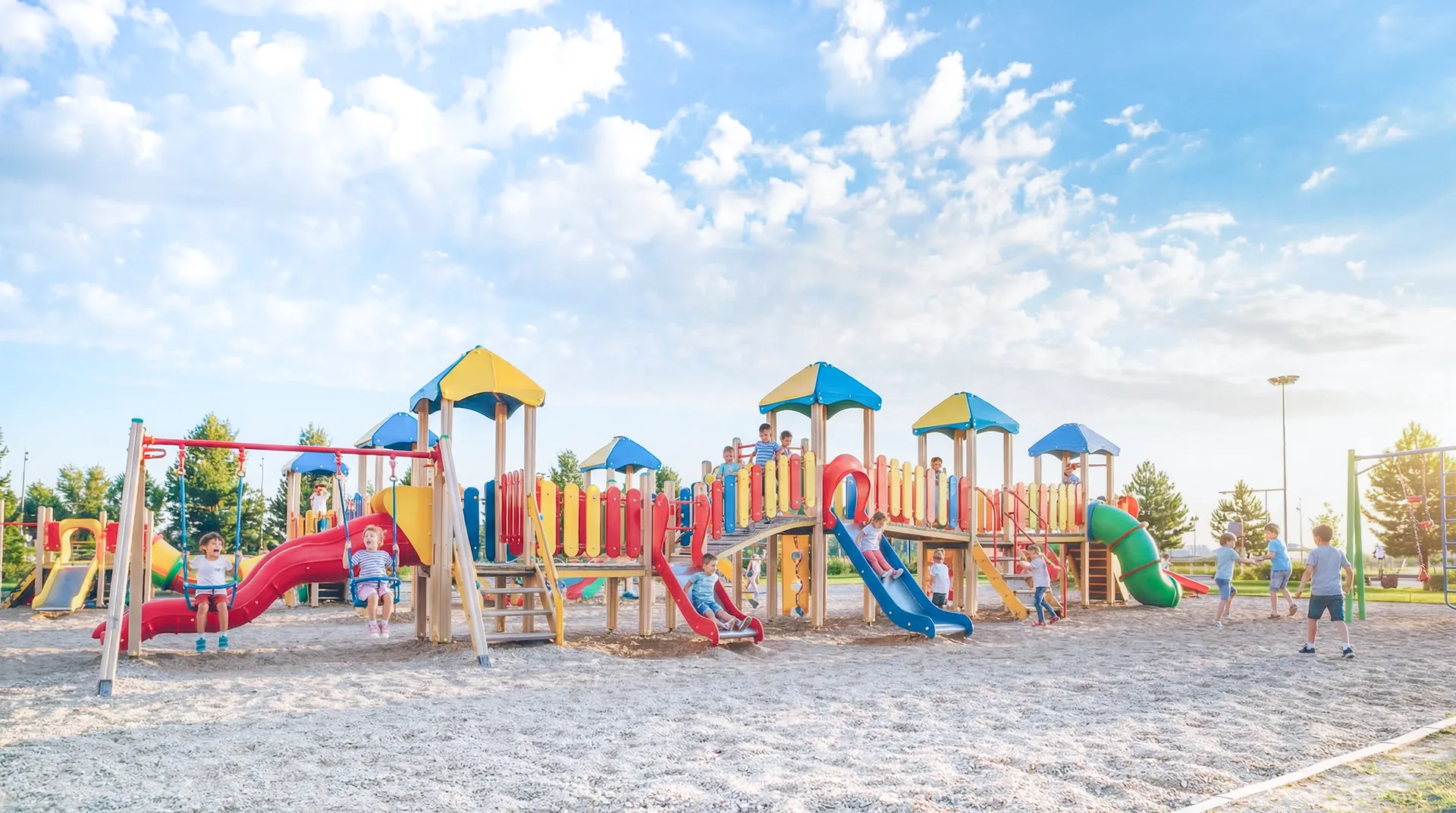 Children playing on a colorful playground under blue sky